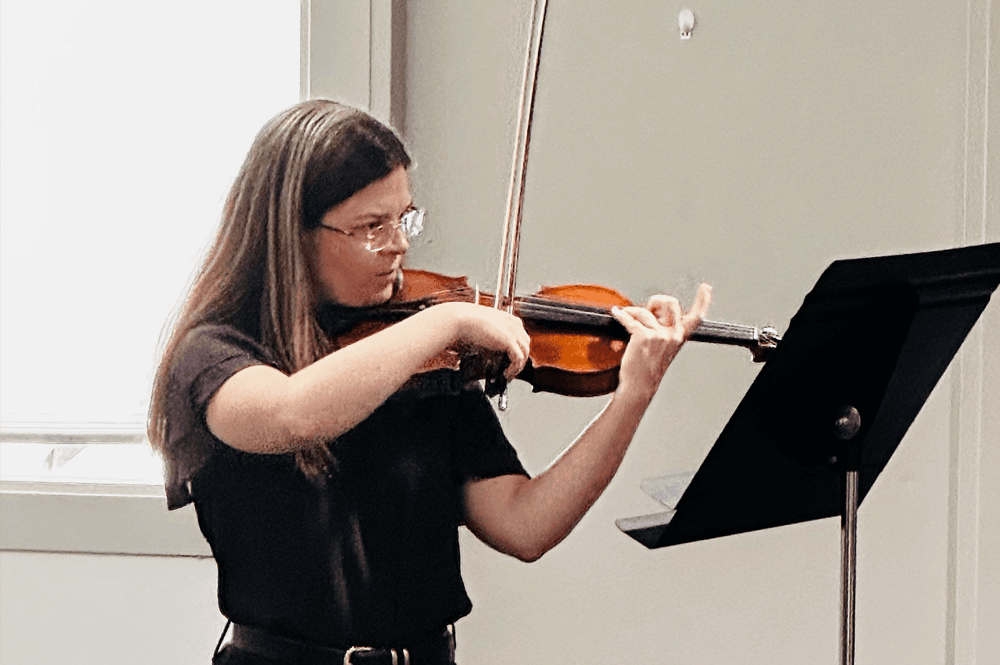 Adult student receiving music instruction
